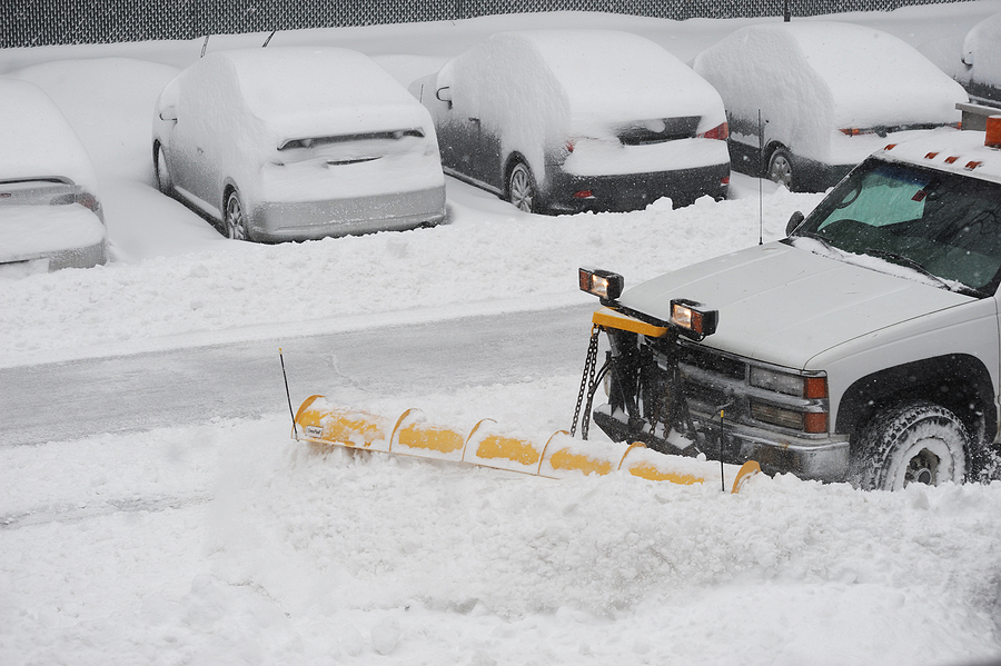 snowplow removing snow on the street after blizzard