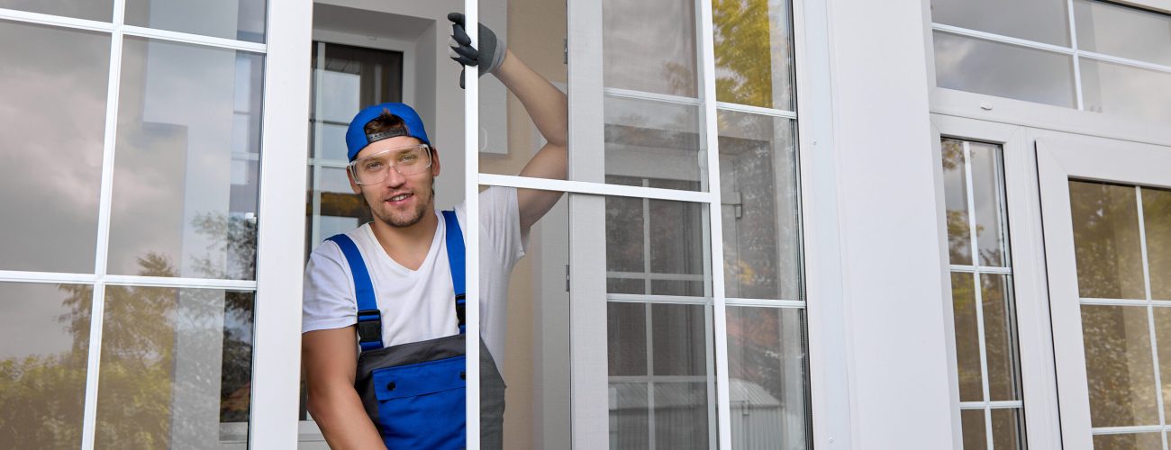 An Experienced Employee Of A Window Company Poses Performing The