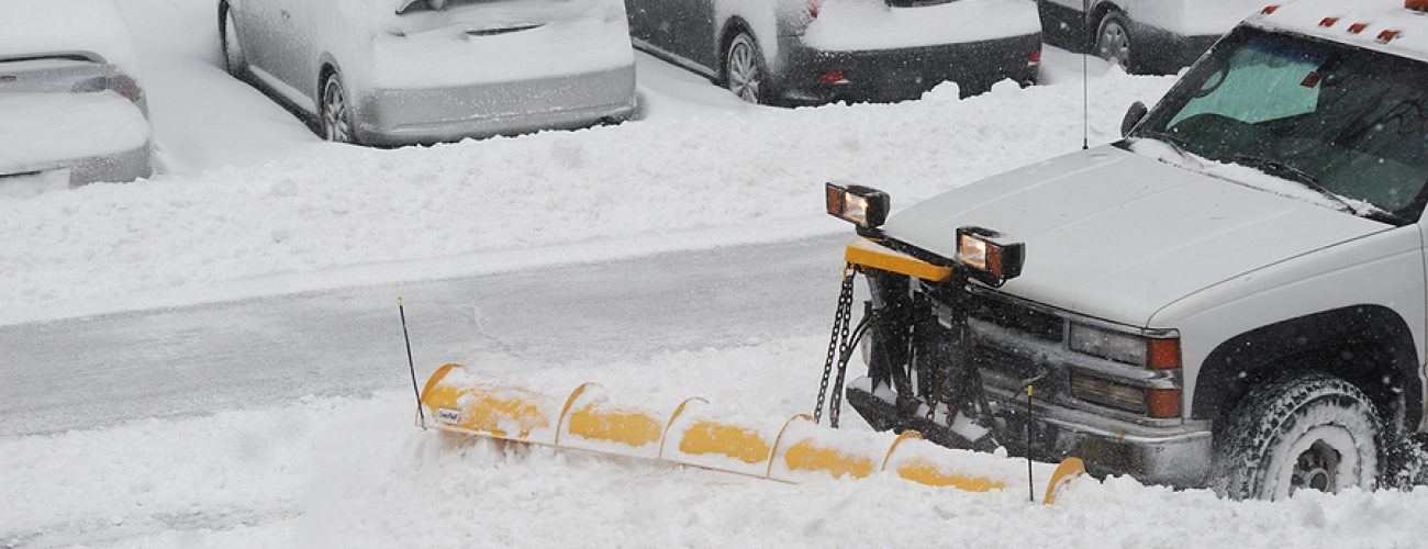 snowplow removing snow on the street after blizzard